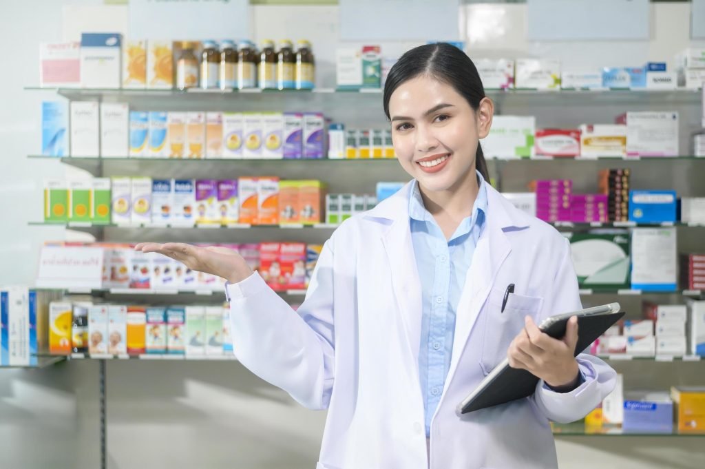 portrait of female pharmacist using tablet in a modern pharmacy drugstore free photo